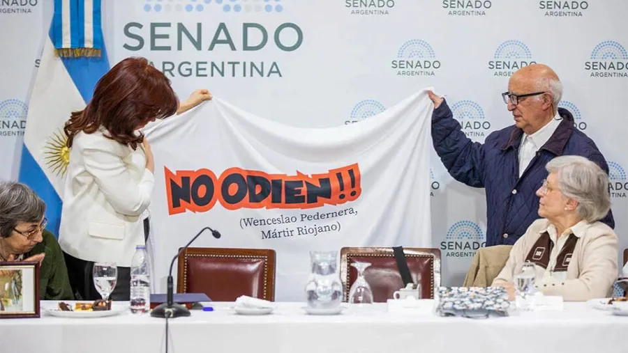 El cura Domingo Bresci y la bandera “No odien”, junto a Cristina Kirchner en el Senado.
